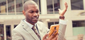 Tsb Black Business Man Stares At Phone 2